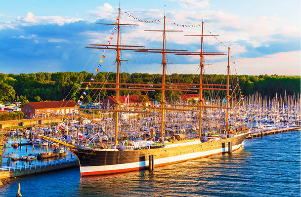 Scenic summer evening view of historical ship Passat in the Old Town pier of Travemunde, Germany